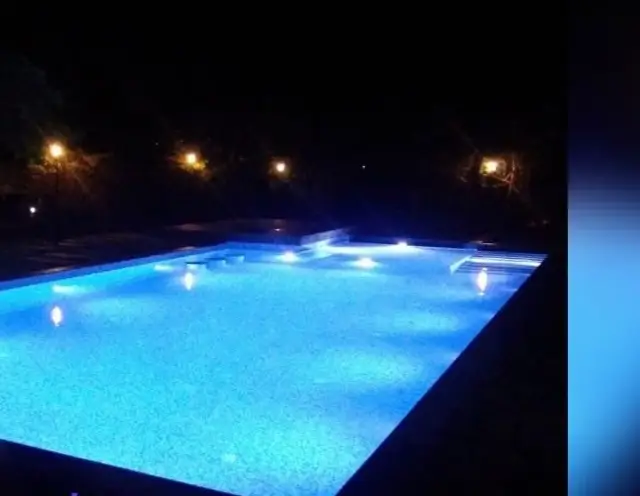 Large resort swimming pool with night lighting